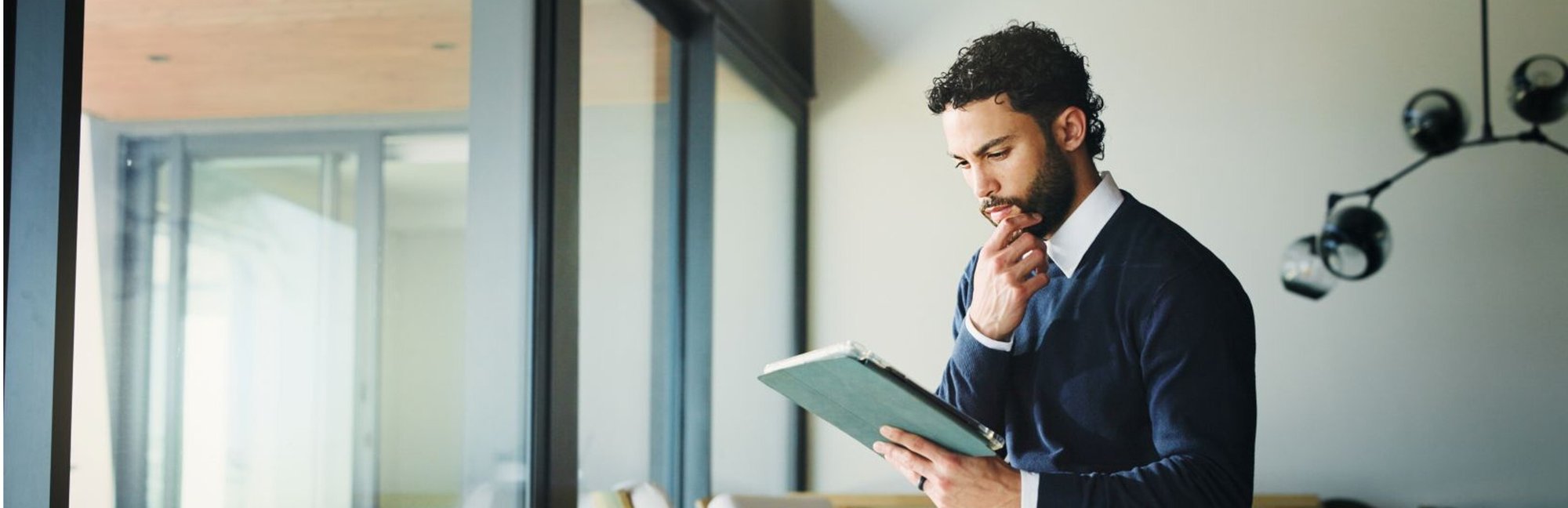 Man thinking and looking at tablet Man thinking and looking at tablet